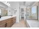Luxurious bathroom features a glass-enclosed shower, soaking tub, and dual vanities at 18150 W Tanglewood Dr, Goodyear, AZ 85338