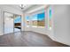 Bright dining room with wood floors, large windows, and sliding glass doors to the backyard at 18150 W Tanglewood Dr, Goodyear, AZ 85338