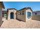 Exterior shot showing paver patio and tan stucco, with blue trim at 18150 W Tanglewood Dr, Goodyear, AZ 85338