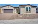 Inviting single-story home with desert landscaping, two-car garage, and arched entryway at 18150 W Tanglewood Dr, Goodyear, AZ 85338