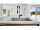 Modern kitchen sink featuring modern faucet and backyard views at 18150 W Tanglewood Dr, Goodyear, AZ 85338