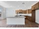 Modern kitchen featuring a large island, stainless appliances, and a beautiful backsplash at 18150 W Tanglewood Dr, Goodyear, AZ 85338