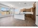 Open kitchen with a large island, hardwood floors, and stainless-steel appliances at 18150 W Tanglewood Dr, Goodyear, AZ 85338