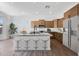Bright kitchen with seating at island and stainless appliances at 18150 W Tanglewood Dr, Goodyear, AZ 85338