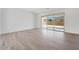 Open living space featuring wood-look tile floors and sliding glass doors at 18150 W Tanglewood Dr, Goodyear, AZ 85338