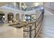 Spacious lobby featuring high ceilings, comfortable seating areas, and a grand staircase with decorative iron railings at 18150 W Tanglewood Dr, Goodyear, AZ 85338