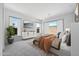 The bedroom boasts neutral tones, two large windows, and elegant decor at 18150 W Tanglewood Dr, Goodyear, AZ 85338
