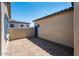 Private paved patio area enclosed by a stucco wall and neighboring property at 18150 W Tanglewood Dr, Goodyear, AZ 85338