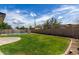 Lush backyard with vibrant green grass and a refreshing fenced swimming pool at 18309 N 39Th Ave, Glendale, AZ 85308