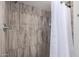 Tiled shower with modern fixtures and a neutral color palette at 18309 N 39Th Ave, Glendale, AZ 85308