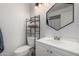 Bright bathroom featuring a modern vanity, geometric mirror, and stylish storage shelf at 18309 N 39Th Ave, Glendale, AZ 85308