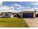 Charming single-story home featuring a well-maintained lawn, a blue garage door, and a covered entry at 18309 N 39Th Ave, Glendale, AZ 85308