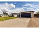 Well-kept single-story home with a blue garage door and a large driveway, perfect for extra parking at 18309 N 39Th Ave, Glendale, AZ 85308