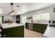 Bright kitchen featuring a large island, stainless steel appliances, and sleek countertops at 18309 N 39Th Ave, Glendale, AZ 85308