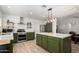 Modern kitchen with stainless steel appliances, a large island, and updated cabinetry at 18309 N 39Th Ave, Glendale, AZ 85308