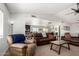 Spacious living room with plush seating, natural light, and an open layout to the dining area at 18309 N 39Th Ave, Glendale, AZ 85308