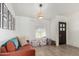 Bright, cozy living room featuring a rustic light fixture, wood floors, and large window at 18309 N 39Th Ave, Glendale, AZ 85308