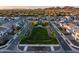 Expansive aerial view of the community's green spaces, well-manicured landscaping, and neatly arranged homes against mountain backdrop at 1919 W Hide Trl, Phoenix, AZ 85085