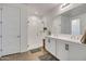 Modern bathroom with double sink vanity, white cabinets, and a glass enclosed shower for a clean and open look at 1919 W Hide Trl, Phoenix, AZ 85085