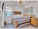 A cozy bedroom featuring a wooden bed frame, light walls, a ceiling fan, and a side table at 1919 W Hide Trl, Phoenix, AZ 85085