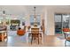 Inviting dining area with a wooden table, a stylish pendant light, and easy access to both the living room and patio at 1919 W Hide Trl, Phoenix, AZ 85085