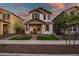 Charming two-story home featuring a welcoming front porch and manicured landscaping against a colorful sunset backdrop at 1919 W Hide Trl, Phoenix, AZ 85085