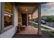 Inviting front porch with brick flooring, wooden bench and decorative accents, perfect for enjoying quiet moments at 1919 W Hide Trl, Phoenix, AZ 85085