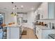 Well-equipped kitchen featuring white cabinetry, granite countertops, stainless steel appliances, and a functional center island at 1919 W Hide Trl, Phoenix, AZ 85085