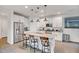Modern kitchen boasts white cabinets, granite countertops, stainless steel appliances, and a large center island with seating at 1919 W Hide Trl, Phoenix, AZ 85085