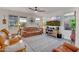 Bright and airy living room with large windows, comfortable seating, stylish decor, and a ceiling fan for added comfort at 1919 W Hide Trl, Phoenix, AZ 85085
