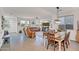 Open-concept living and dining area with wood-look tile flooring, ample natural light, and a seamless flow for entertaining at 1919 W Hide Trl, Phoenix, AZ 85085