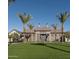 Beautiful recreation center featuring a well-kept lawn and flanked by tall palm trees under a bright blue sky at 1919 W Hide Trl, Phoenix, AZ 85085