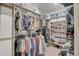 Spacious walk-in closet with ample shelving, hanging rods, and an organized layout for easy storage at 1919 W Hide Trl, Phoenix, AZ 85085