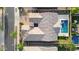 Aerial view of a house with a tiled roof, surrounded by lush greenery and a sparkling blue pool and hot tub at 22296 E Maya Rd, Queen Creek, AZ 85142