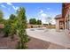Spacious backyard showcasing a large patio, sparkling pool, and lush landscaping, perfect for outdoor enjoyment at 22296 E Maya Rd, Queen Creek, AZ 85142