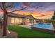 Spacious backyard with a pool, spa, and well-maintained lawn, ideal for recreation and relaxation at 22296 E Maya Rd, Queen Creek, AZ 85142