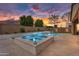 Luxurious backyard featuring a pool, spa, and ample patio space, perfect for outdoor gatherings at 22296 E Maya Rd, Queen Creek, AZ 85142
