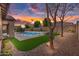 Beautifully landscaped backyard featuring a pool, spa, and synthetic grass for easy maintenance at 22296 E Maya Rd, Queen Creek, AZ 85142