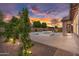 Lush backyard showcasing a pool, spa, and desert landscaping with ambient lighting at 22296 E Maya Rd, Queen Creek, AZ 85142