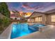 Inviting backyard oasis with a sparkling pool, spa, and patio area for outdoor living at 22296 E Maya Rd, Queen Creek, AZ 85142