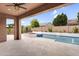 Back patio with view of pool, spa and outdoor seating, with view to the well maintained greenery and landscaping at 22296 E Maya Rd, Queen Creek, AZ 85142