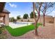 Private backyard retreat with a modern pool, manicured lawn, and mature trees creating a serene outdoor oasis at 22296 E Maya Rd, Queen Creek, AZ 85142