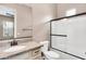 Bright bathroom featuring granite counters, updated fixtures, and a shower-tub combo with a glass screen at 22296 E Maya Rd, Queen Creek, AZ 85142