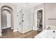 Modern bathroom design showcasing glass-enclosed shower, soaking tub, and elegant tile work at 22296 E Maya Rd, Queen Creek, AZ 85142