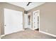 Bedroom with neutral walls, plush carpet, closet, and a view to an en-suite bathroom and living space at 22296 E Maya Rd, Queen Creek, AZ 85142