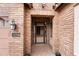 Inviting home entrance featuring a security door, lantern lighting, and manicured landscaping creating curb appeal at 22296 E Maya Rd, Queen Creek, AZ 85142
