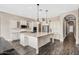 Modern kitchen with a spacious island, stainless steel appliances, white cabinets, and tile flooring at 22296 E Maya Rd, Queen Creek, AZ 85142