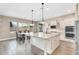 Gourmet kitchen featuring white cabinets, granite island, stainless steel appliances and an adjacent dining area at 22296 E Maya Rd, Queen Creek, AZ 85142