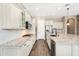 Bright kitchen with white cabinets, granite countertops, stainless appliances, and tile backsplash at 22296 E Maya Rd, Queen Creek, AZ 85142