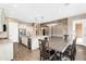 Open concept kitchen and dining area with island, granite countertops and stainless steel appliances at 22296 E Maya Rd, Queen Creek, AZ 85142